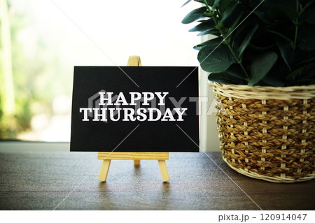Happy Thursday text on paper card with ealsel on wooden background Happy Thursday text on paper card with ealsel on wooden background 120914047