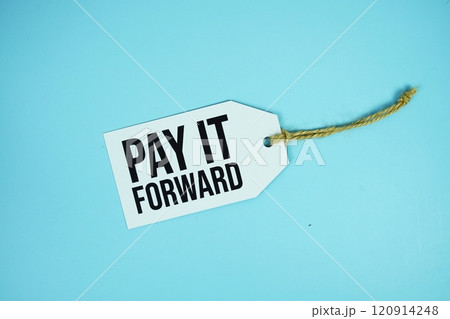 Pay It Forward text on price tage top view on blue background 120914248