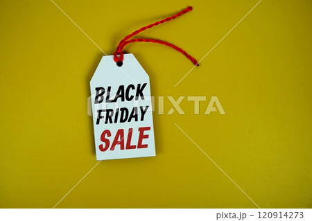 Black Friday Sale on price tag with wooden clothes hanger top view on yellow background Black Friday Sale on price tag with wooden clothes hanger top view on yellow background 120914273