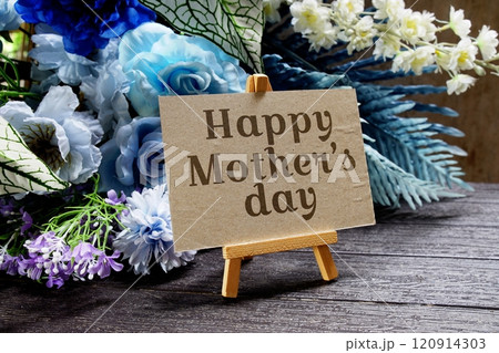 Happy Mother's day text write on paper card with wooden easel and flowers decoration on wooden background Happy Mother's day text write on paper card with wooden easel and flowers decoration on wooden background 120914303