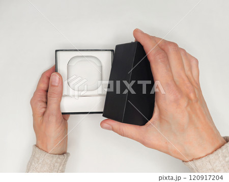 woman hand actively unboxing the latest wireless earbuds contain woman hand actively unboxing the latest wireless earbuds contain 120917204