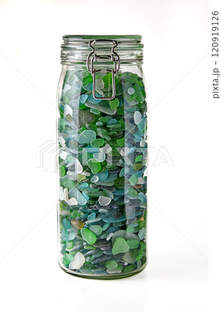 glass jar with blue and green shards of sea glass isolated on white background glass jar with blue and green shards of sea glass isolated on white background 120919126