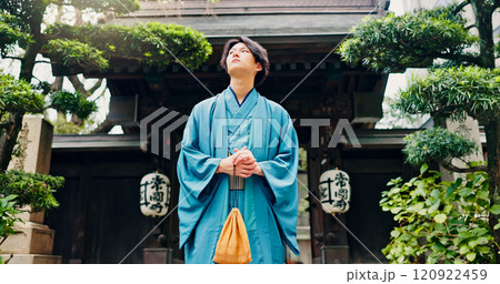 Kimono, thinking and low angle with Japanese man at temple for Shinto ceremony, fashion and prayer. Respect, travel and reflection with person in japan for traditional clothes, Buddhism and festival 120922459