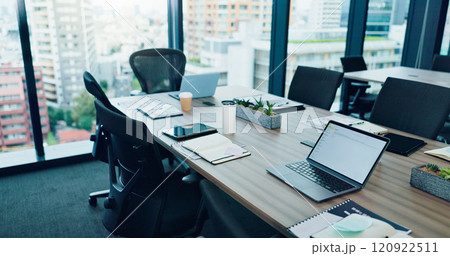 Empty, table and laptop on table for conference room, corporate company and meeting boardroom. Vacant, interior furniture and chairs in workplace for planning, business brief and tech agency in Japan 120922511