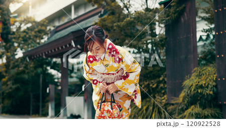 Bow, kimono and Asian woman in city for ceremony, ritual and respect at temple in Japan. Outdoors, culture and person in traditional clothes with gesture for gratitude, prayer and custom in town 120922528