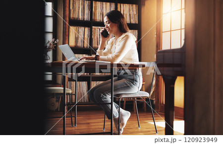 Woman, smile and phone call at laptop for remote work, planning or negotiation feedback in home. Japanese person, tech or contact at table for discussion, brainstorming or consultation for networking 120923949