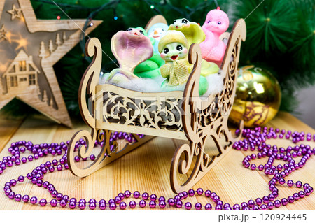 Charming Handmade Snowman and Snake Soap Figures in Rustic Wooden Sled: A Whimsical Winter Scene That Captures the Joy of the Season, Perfect for Holiday Decor and Unique Gifting Ideas 120924445