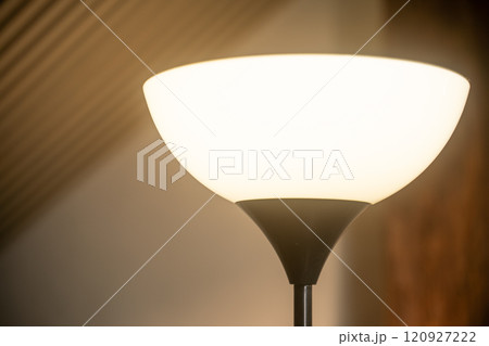 Lamp lighting up in cozy room during evening ambience Lamp lighting up in cozy room during evening ambience 120927222