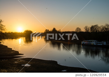 夜明け前の朝焼けが映るテームズ川と冬の枝木と街灯が並ぶ街並み　ロンドン郊外のキュー・ブリッジにて 120929554