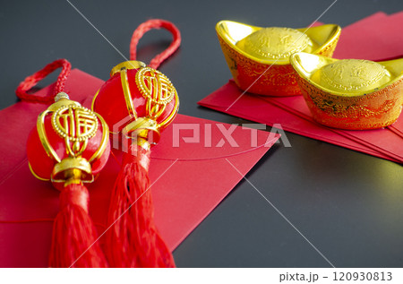 Chinese New Year decoration with golden ingots and Chinese New Year balls on red packets 120930813