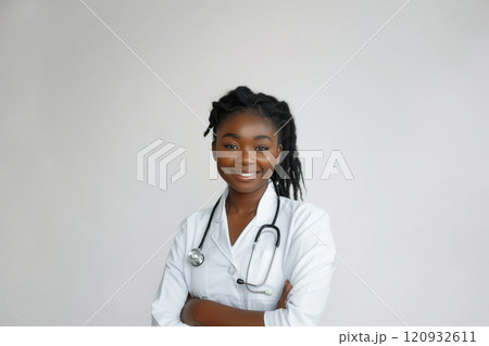 Portrait of smiling african american female doctor in medical uniform holding stethoscope on white background Portrait of smiling african american female doctor in medical uniform holding stethoscope on white background 120932611