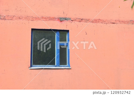 Grunge urban background texture of old orange concrete wall with window, blue wooden frame. 120932742