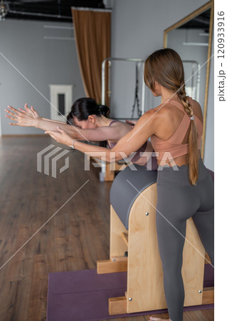 Modern Pilates studio with bright, spacious windows for exercise and wellbeing 120933916