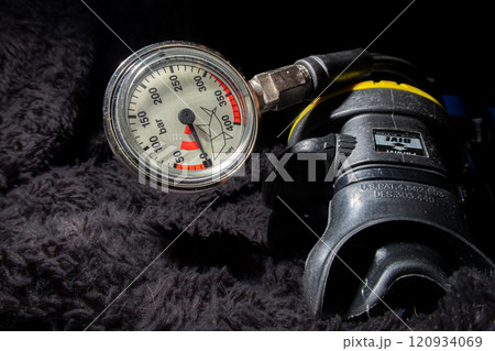 Scuba diving pressure gauge and a second stage air regulator close up Scuba diving pressure gauge and a second stage air regulator close up 120934069