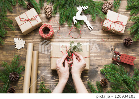 Christmas giftbox wrapping in craft paper. Xmas Holiday card. Christmas giftbox wrapping in craft paper. Xmas Holiday card. 120934103