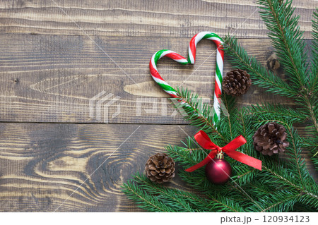 Christmas tree branches with decor of candy cane, pine cones. Xmas card. Christmas tree branches with decor of candy cane, pine cones. Xmas card. 120934123