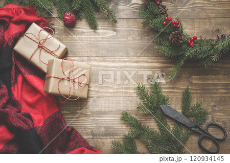 Christmas composition of wreath, gifts on wooden board. Xmas card 120934145