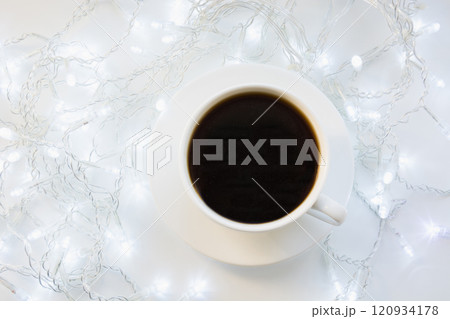 Cup of black coffee on winter white table. Xmas holiday time. Top view. Cup of black coffee on winter white table. Xmas holiday time. Top view. 120934178