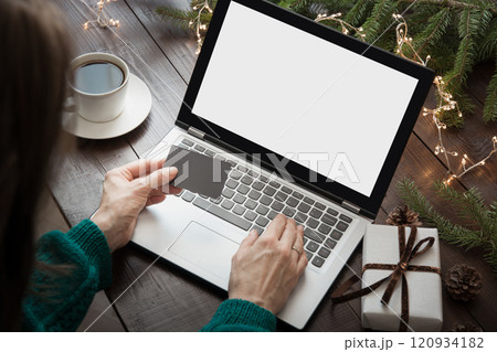Christmas sales. Woman shopping with credit card by laptop in home. Xmas. 120934182