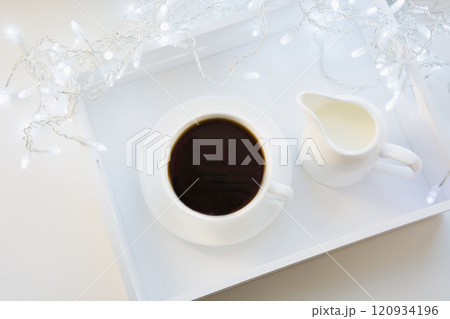 Cup of black coffee on winter white table. Xmas holiday time. Top view. 120934196