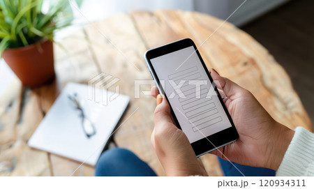Clear digital consumer survey form on smartphone screen, held by hand, simple interface. Consumer survey answer form 120934311