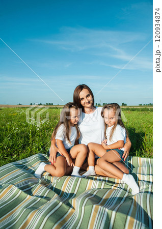 A mother and her daughter are having fun in a field. A mother and her daughter are having fun in a field. 120934874