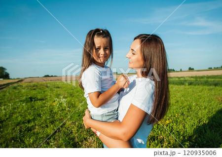 The family spends leisure time in the fresh air. Sisters are having fun. 120935006