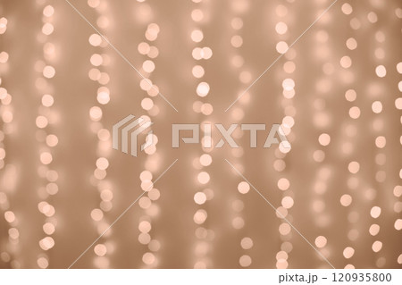 Fairy lights hanging on brown wall 120935800