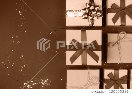 Elegant gift boxes with bows showcased on a sparkling festive background Elegant gift boxes with bows showcased on a sparkling festive background 120935851
