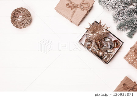 Festive decorations and gifts arranged on a wooden table for the holiday season 120935871