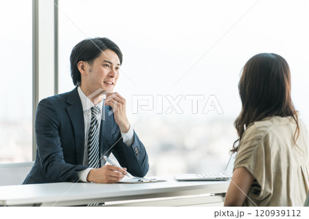 投資信託・マネー相談・個別相談会で接客するビジネスマンとカウンセリングを受ける顧客の女性 投資信託・マネー相談・個別相談会で接客するビジネスマンとカウンセリングを受ける顧客の女性 120939112