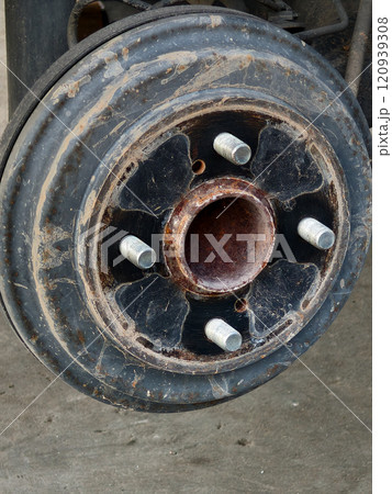 close-up of a wheel hub being removed from a vehicle. close-up of a wheel hub being removed from a vehicle. 120939308