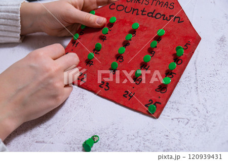 Wooden Christmas advent calendar in shape of house Gift idea. Do it yourself instruction eco-friendly decoration. Zero waste Making handmade presents children's diy projects. Holiday family time 120939431