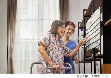 Confused Asian Elderly Woman With Dementia Looking At Wall Calendar. 120939599