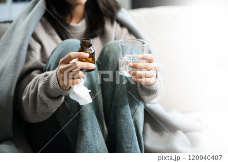 woman holding bottle with pills on hand going to take medicaments prescribed by his physician woman holding bottle with pills on hand going to take medicaments prescribed by his physician 120940407
