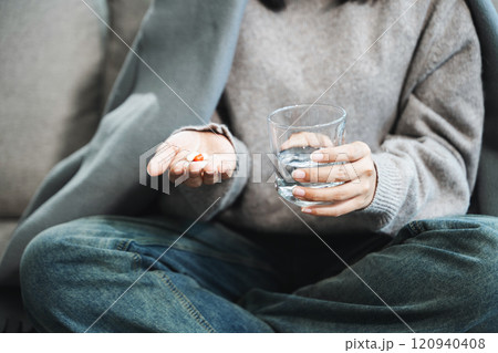 woman holding bottle with pills on hand going to take medicaments prescribed by his physician woman holding bottle with pills on hand going to take medicaments prescribed by his physician 120940408
