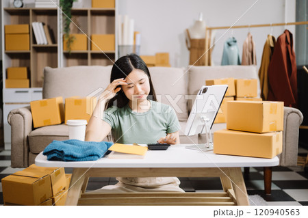 Asian owner woman prepare parcel box woman is stressed, bored, and overthinking from working and standing check online orders for deliver to customer. Asian owner woman prepare parcel box woman is stressed, bored, and overthinking from working and standing check online orders for deliver to customer. 120940563