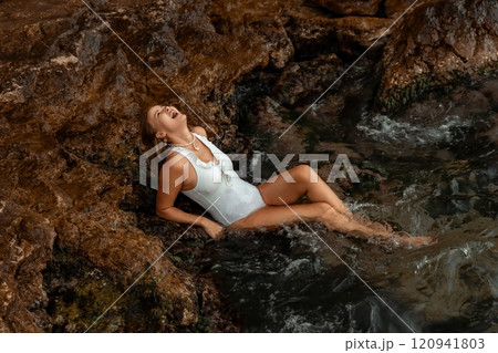 Woman, Waterfall, Rocks - A woman in a white swimsuit sits in a waterfall, surrounded by rocks. 120941803