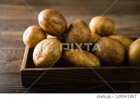 fresh potatoes in a wooden box fresh potatoes in a wooden box 120941867
