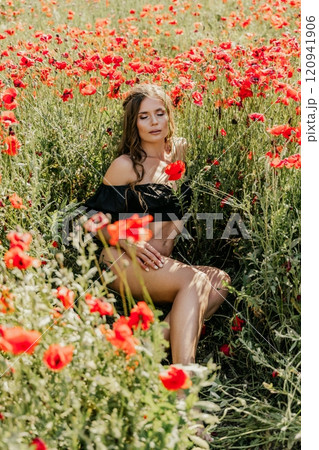 Woman poppies field. portrait happy woman with long hair in a poppy field and enjoying the beauty of nature in a warm summer day. Woman poppies field. portrait happy woman with long hair in a poppy field and enjoying the beauty of nature in a warm summer day. 120941906