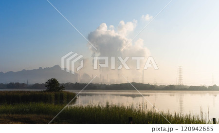 Aerial view of a coal-fired power plant with steam flowing out of the stack in the morning. Mae Moh Power Plant, Lampang, Thailand. Aerial view of a coal-fired power plant with steam flowing out of the stack in the morning. Mae Moh Power Plant, Lampang, Thailand. 120942685