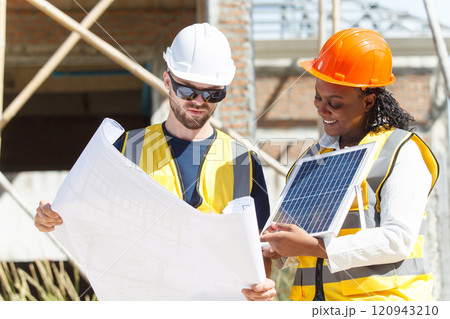 Professional - senior civil engineers inspecting or working in construction site, contractor examining a building blueprint or layout on paper. Professional - senior civil engineers inspecting or working in construction site, contractor examining a building blueprint or layout on paper. 120943210