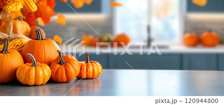 Warm pumpkins and autumn leaves create cozy kitchen atmosphere Warm pumpkins and autumn leaves create cozy kitchen atmosphere 120944800