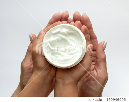 Close up of woman and childs hands holding hand cream on white background. Skincare and moisturizing concept. Design for healthcare, beauty, wellness, and family care poster 120946906