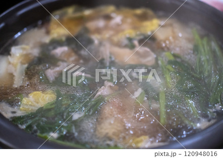Close-up of hot pot, clear soup with vegetable and meat 120948016