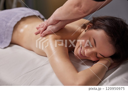 Luxurious Treatment, Spa Ambiance, Luxurious Aromatherapy. Woman is being treated to therapeutic massage session that utilizes power essential oils at spa. 120950975