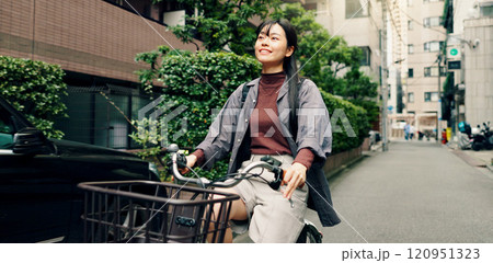 Travel, happy and Asian woman with bicycle in city for morning commute, adventure and journey outdoors. Location, cycling and person on bike for trip, sustainable and eco friendly transport in Japan 120951323