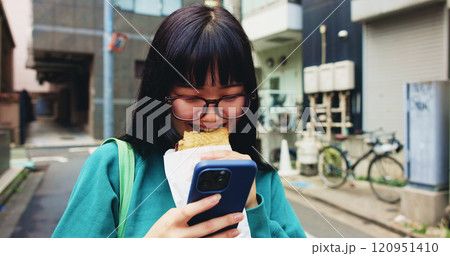 Browsing, smile and woman with smartphone, snack and reading of timetable for exam, eating and campus. Outdoor, education and Asian person with food, scroll and check of schedule, mobile and Japan 120951410