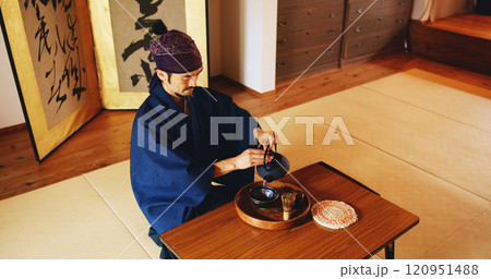 Man, zen and tea ceremony in Japan for tradition, culture and matcha in home with preparation. Male person, ritual and bowl for mindfulness, relax and buddhism with spiritual, respect and harmony 120951488