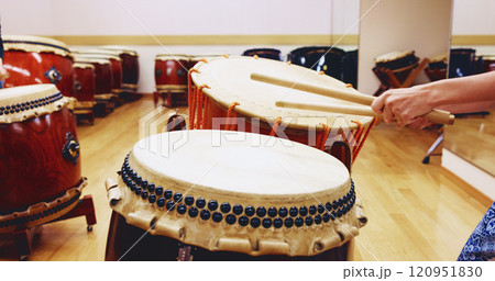 Japanese, drums or hands of person in practice for music on instrument for stage performance, creativity or talent. Taiko, stick or drummer in studio to play in rehearsal for culture, rhythm and beat Japanese, drums or hands of person in practice for music on instrument for stage performance, creativity or talent. Taiko, stick or drummer in studio to play in rehearsal for culture, rhythm and beat 120951830
